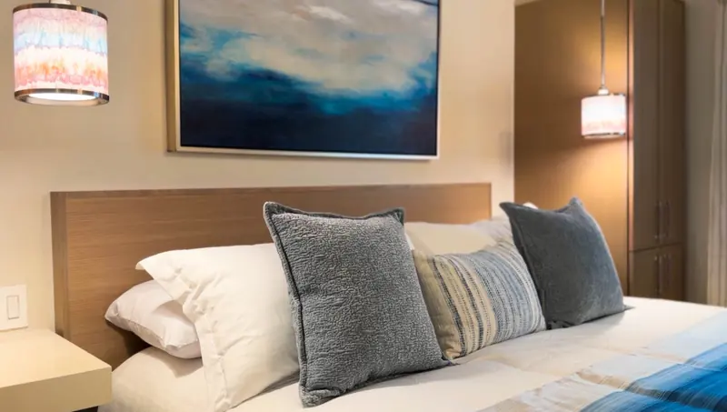 King bed pillows and coastal artwork