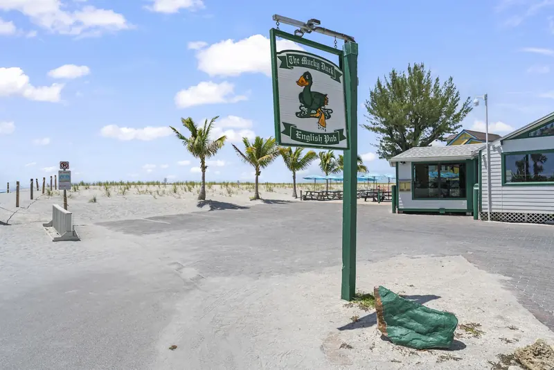 The Mucky Duck sign and beach
