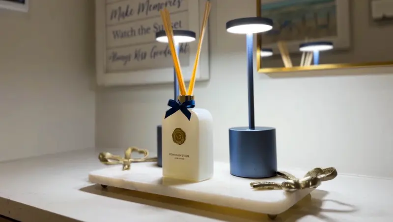 Reed diffuser and lamp on a marble tray